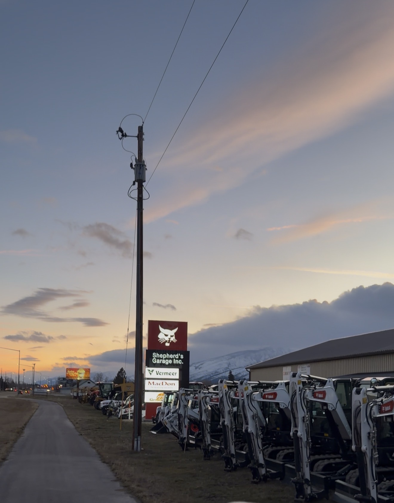The Shepherd’s Garage Victor dealership and equipment yard at sunset